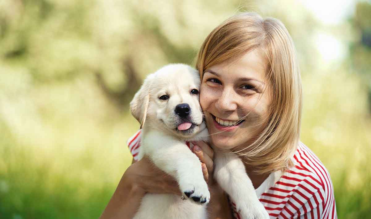 woman with labrador puppy